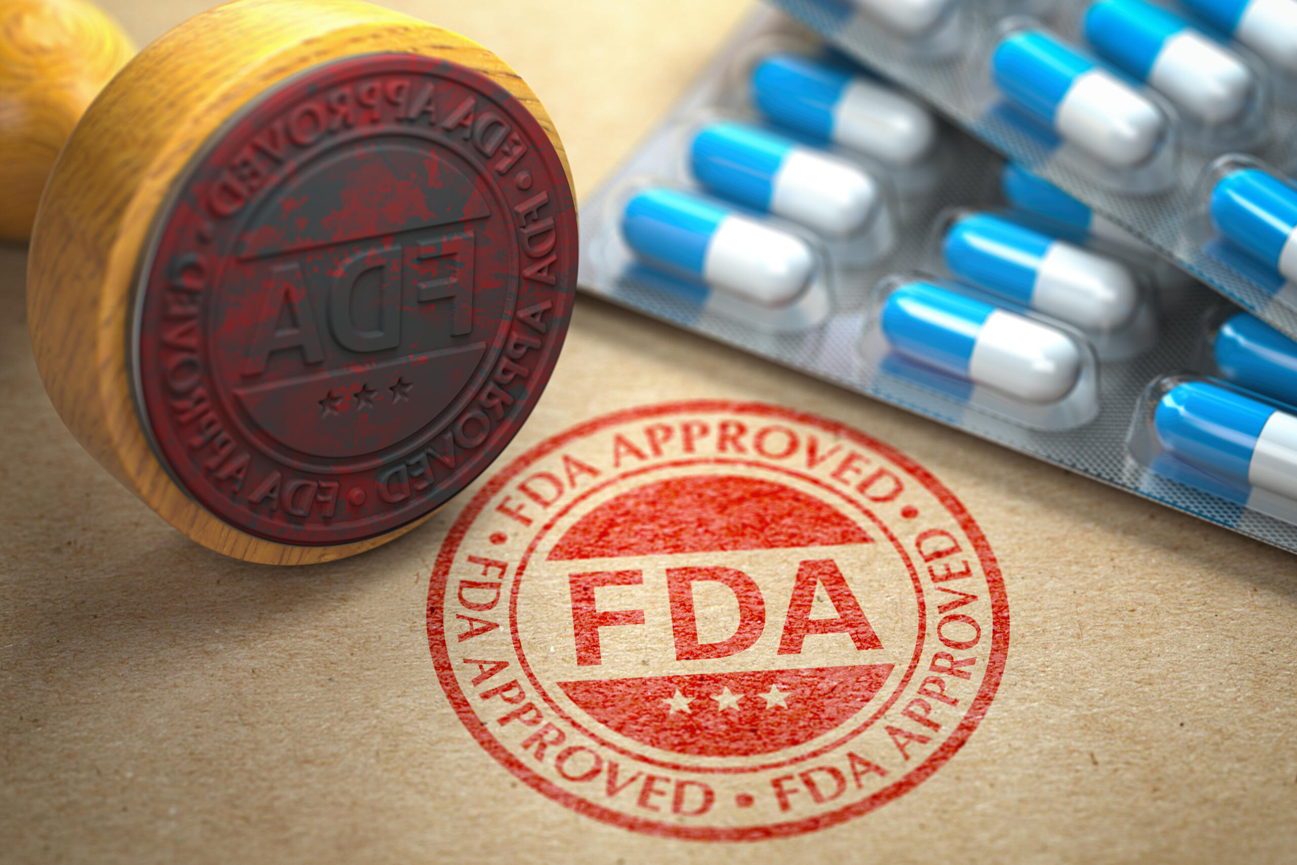 Red FDA approval stamp beside blue and white pills.