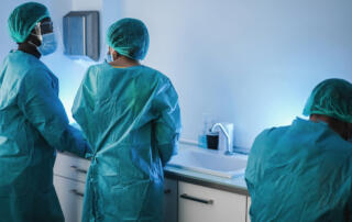 medical workers in hazmat suit working inside laboratory hospital during coronavirus outbreak.