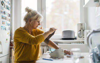 Senior woman measuring blood pressure at home