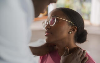 Black Physician Inspect Neck Muscles For Any Damages of a Female African Patient During a Recovery Check Up Visit to a Clinic. Doctor Working in Modern Hospital Office
