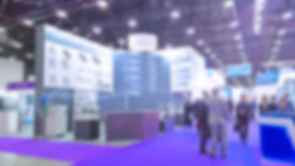 Abstract blur people in trade show background. New modern exhibition, convention and conference expo centre.